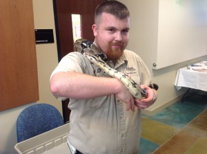 Man with a python wrapped around him