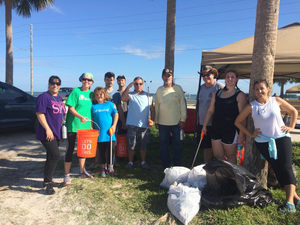 SPC group photo with trash collected. The event was organized by Christina Kugeares, SPC math tutor and Wildlife Rehab Specialist, on the right.